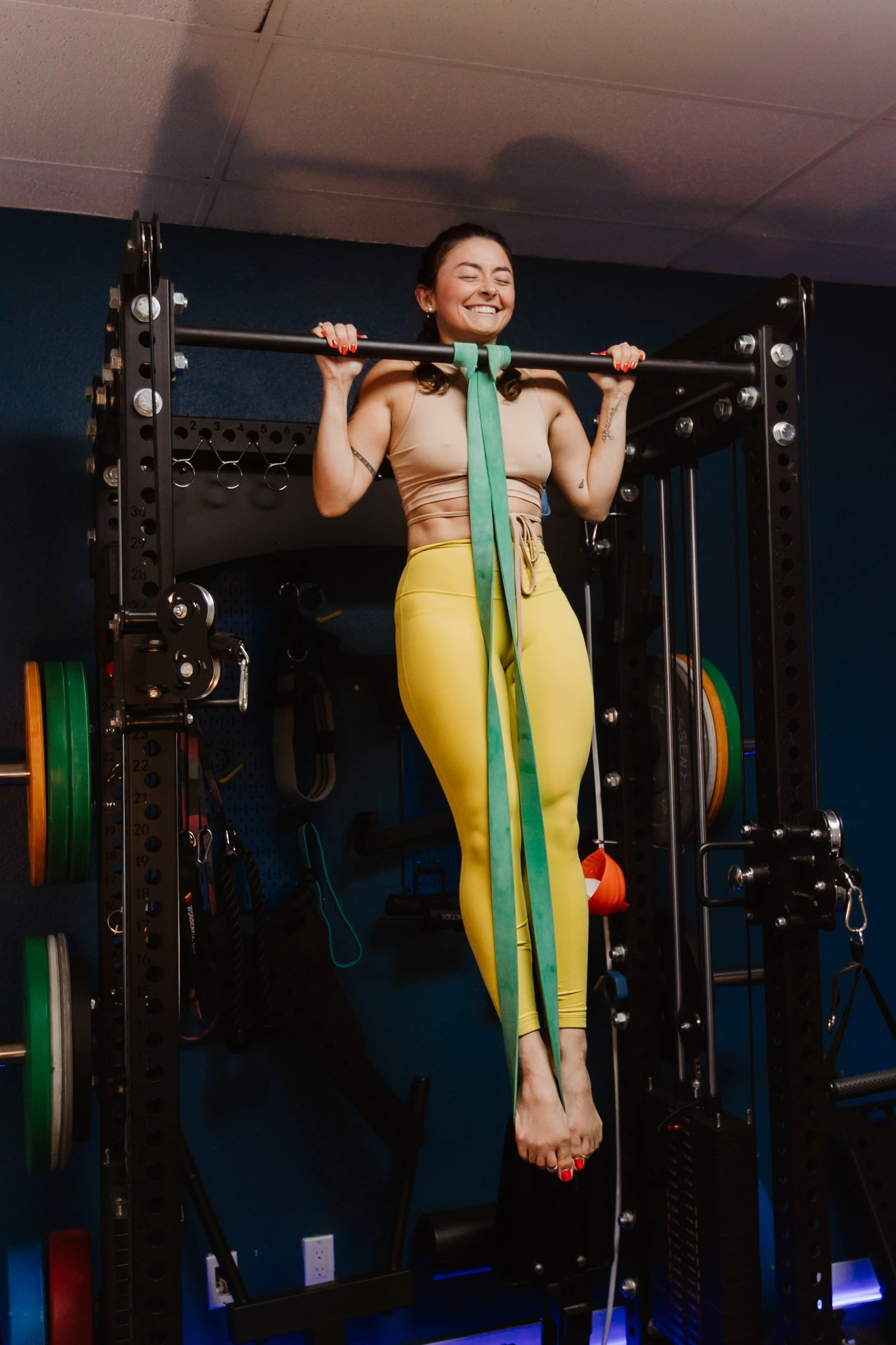 A member practicing an assisted pull-up at Ohm Gym