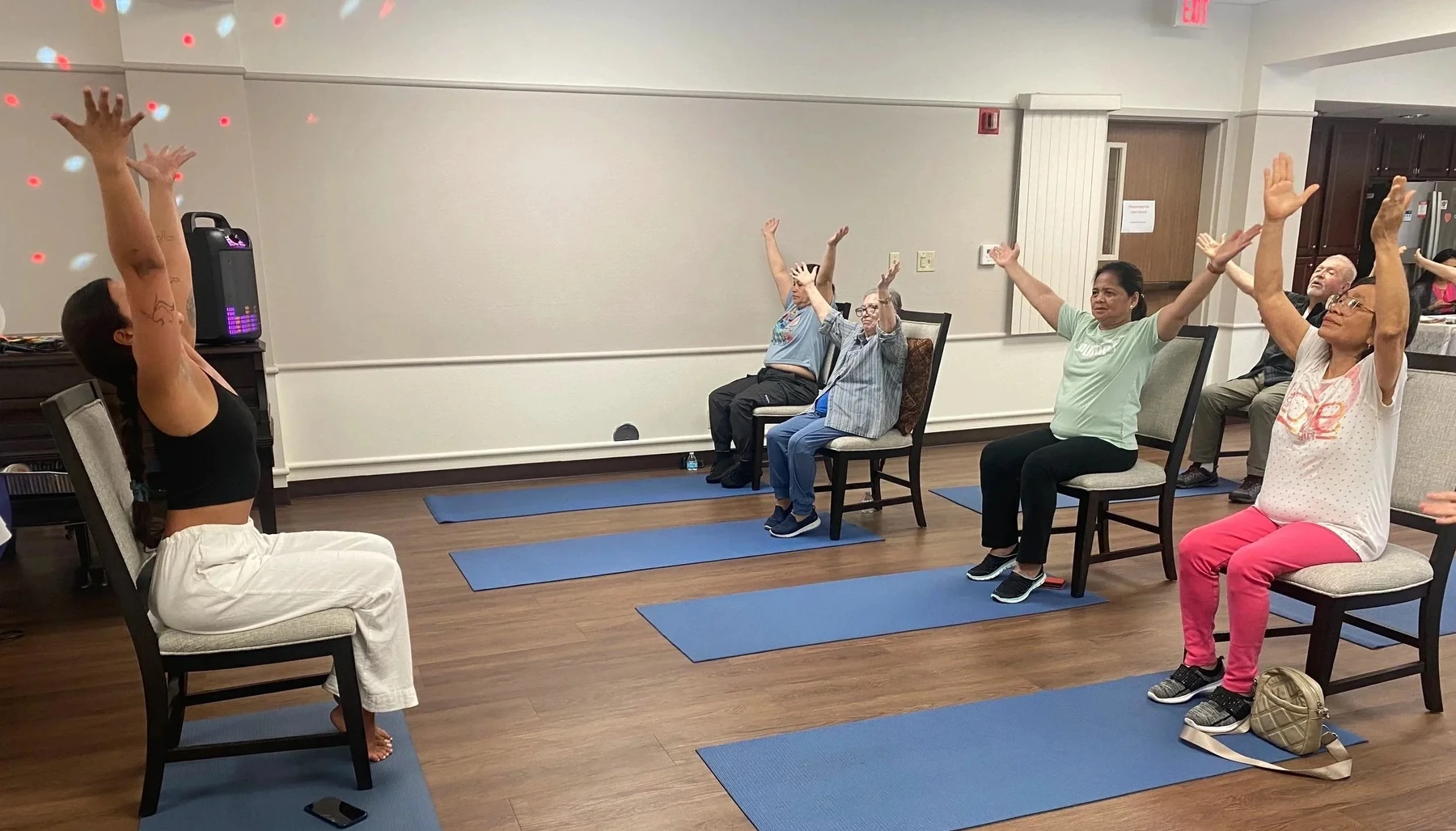 Older adults participating in a seated yoga class